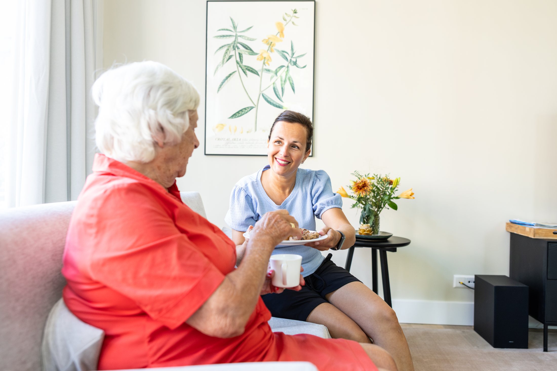 A caregiver and resident having coffee together at Het Gastenhuis